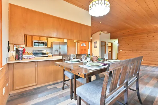 a view of a dining room with furniture a chandelier and wooden floor