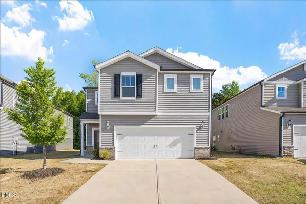 a front view of a house with a yard