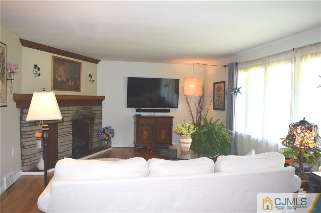 275 Friendship Road Cranbury, NJ 08512 - Photo 2 of 23 a living room with furniture and a flat screen tv