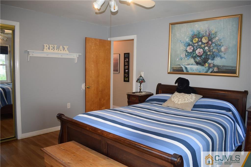 275 Friendship Road Cranbury, NJ 08512 - Photo 13 of 23 a bedroom with a bed and a painting on the wall