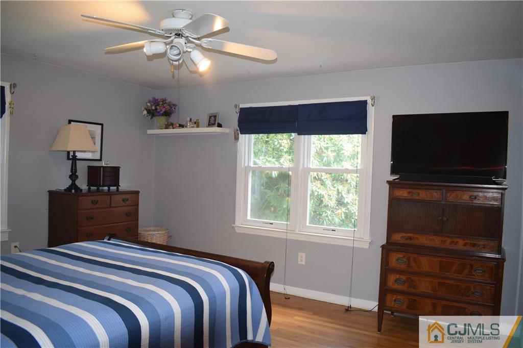 275 Friendship Road Cranbury, NJ 08512 - Photo 14 of 23 a bedroom with a bed and a flat tv screen on dresser