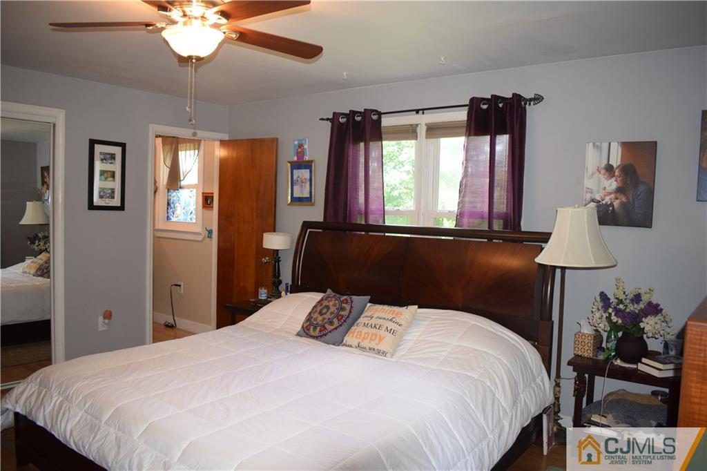 275 Friendship Road Cranbury, NJ 08512 - Photo 15 of 23 a bedroom with a bed and a chandelier