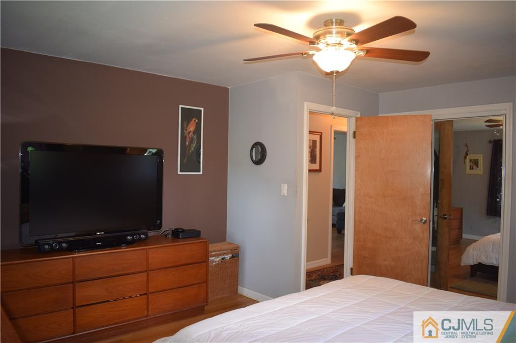 275 Friendship Road Cranbury, NJ 08512 - Photo 16 of 23 a room with a flat screen tv and a ceiling fan