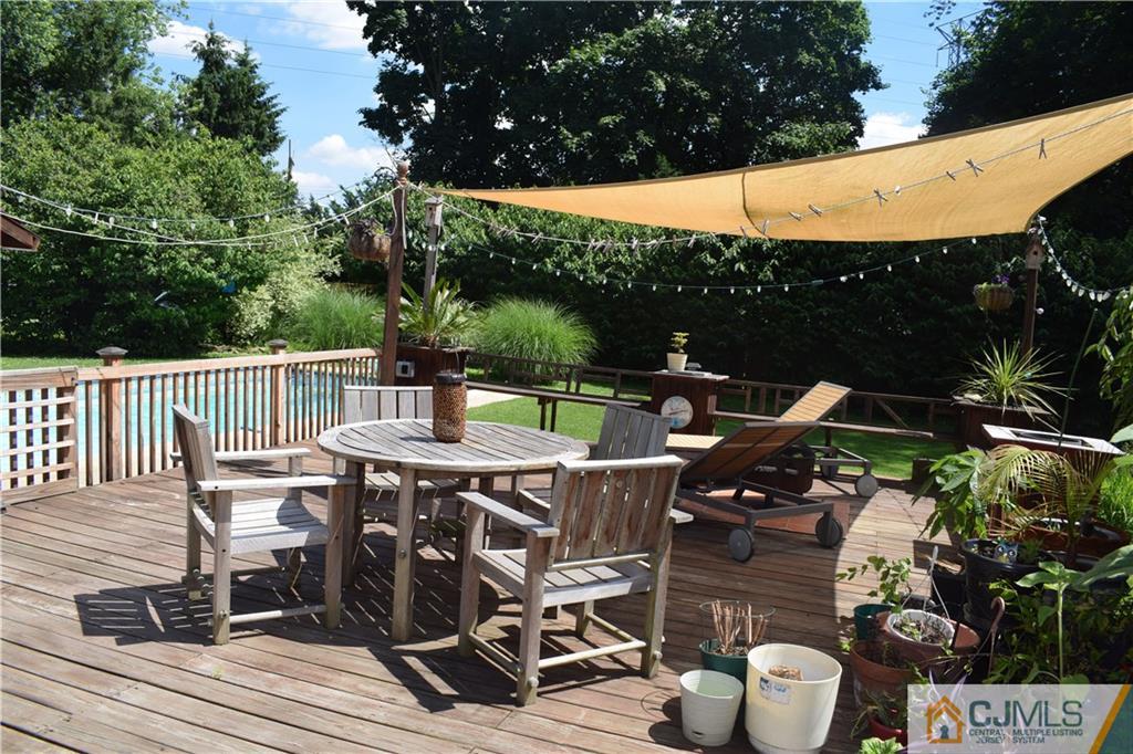 275 Friendship Road Cranbury, NJ 08512 - Photo 21 of 23 a view of a patio with table and chairs with wooden floor and fence