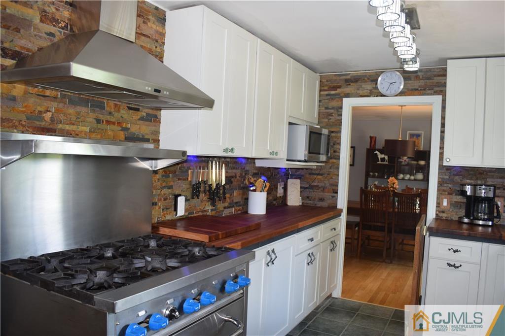 275 Friendship Road Cranbury, NJ 08512 - Photo 9 of 23 a kitchen with stainless steel appliances granite countertop a stove and a refrigerator