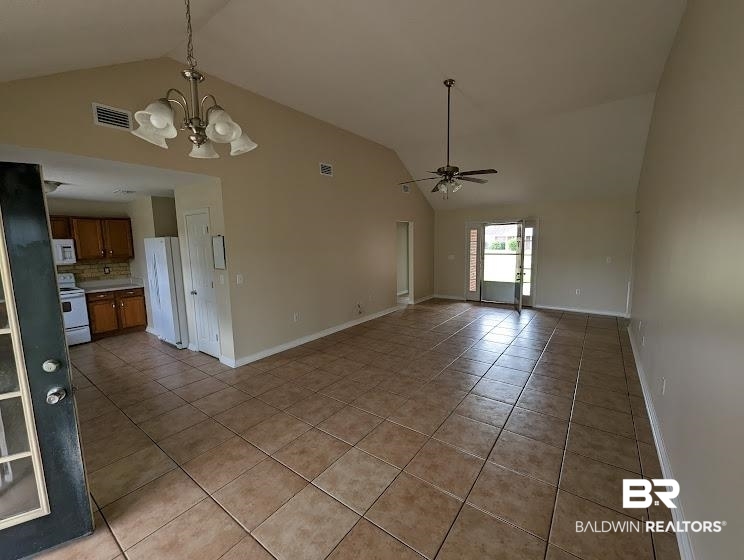 12971 Labradors Run Foley, AL 36535 - Photo 3 of 23 Spacious living area featuring vaulted ceilings, tile flooring, a ceiling fan, and a chandelier