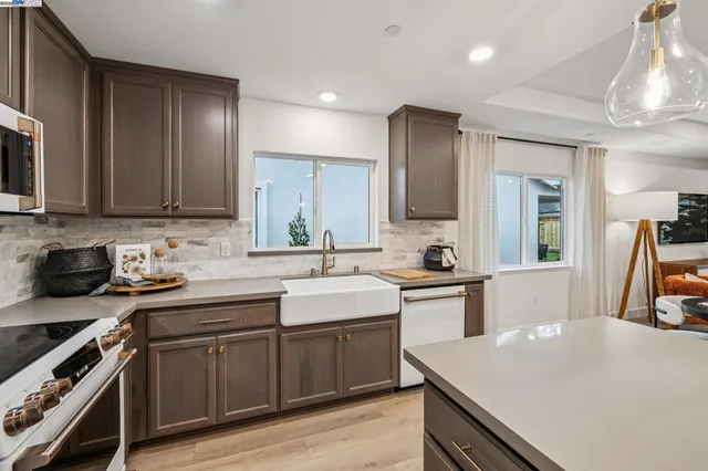 a kitchen with a sink a stove and cabinets