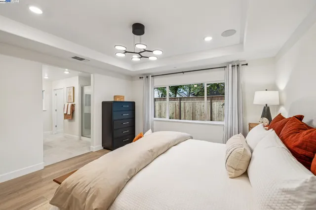 a bedroom with a bed and a large mirror