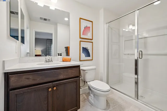 a bathroom with a sink vanity mirror and toilet