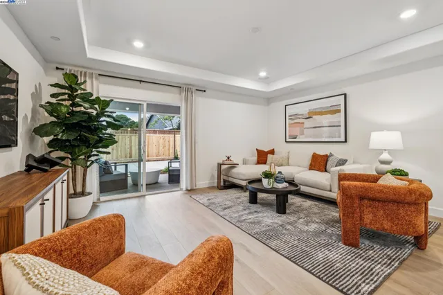 a living room with furniture a couch and a potted plant
