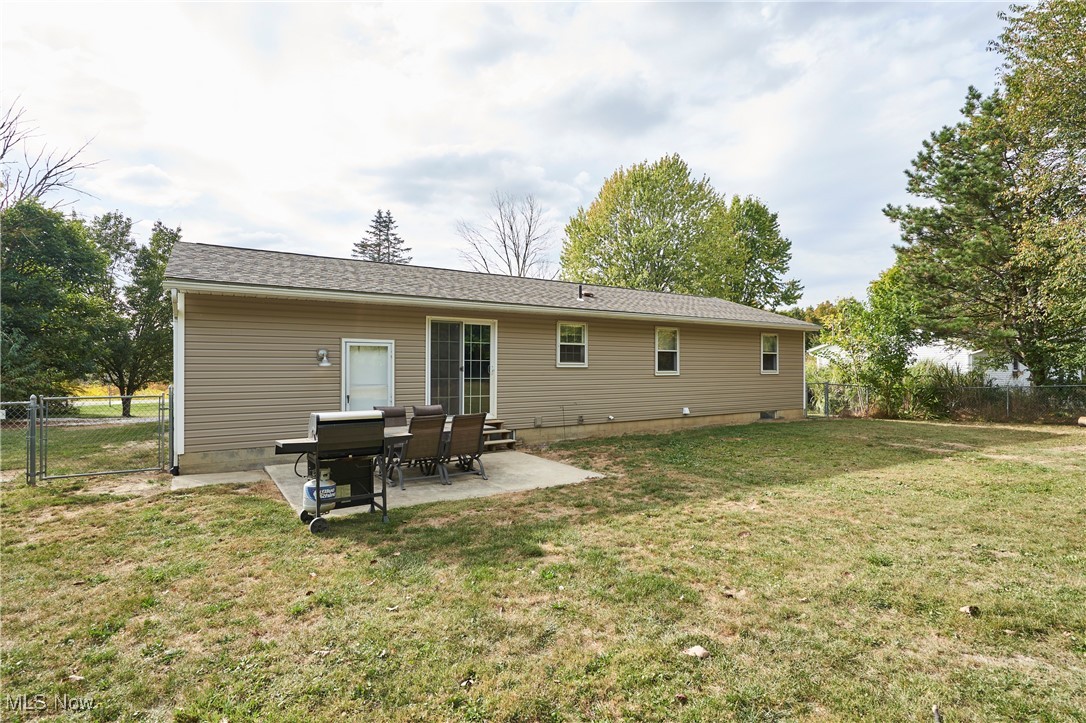 8111 Lake Road Seville, OH 44273 - Photo 28 of 29 Back of house featuring a lawn and a patio area