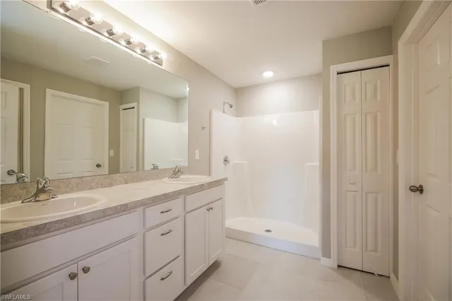 a spacious bathroom with a granite countertop sink a mirror and a
