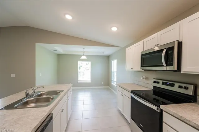 a kitchen that has a sink and a stove in it