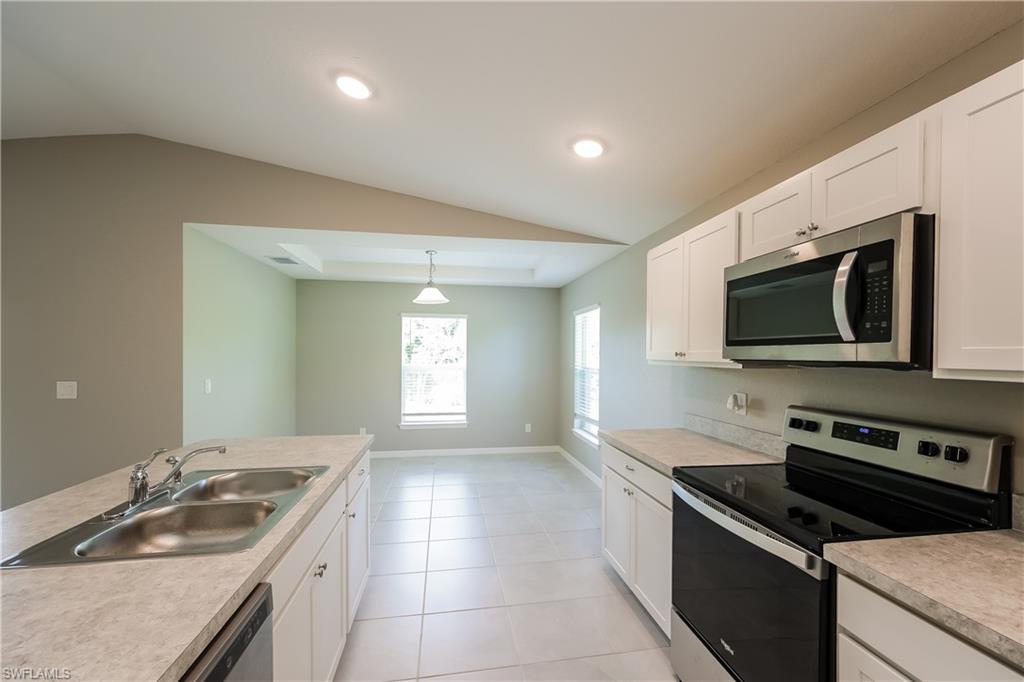 1218 Beaver Street East Lehigh Acres, FL 33974 - Photo 5 of 15 a kitchen that has a sink and a stove in it