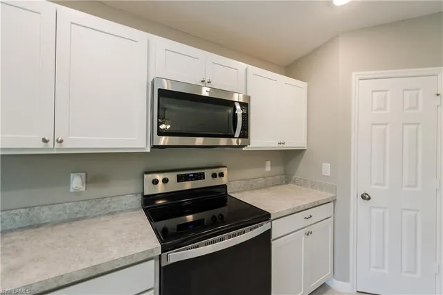 a kitchen with a sink and a stove top oven