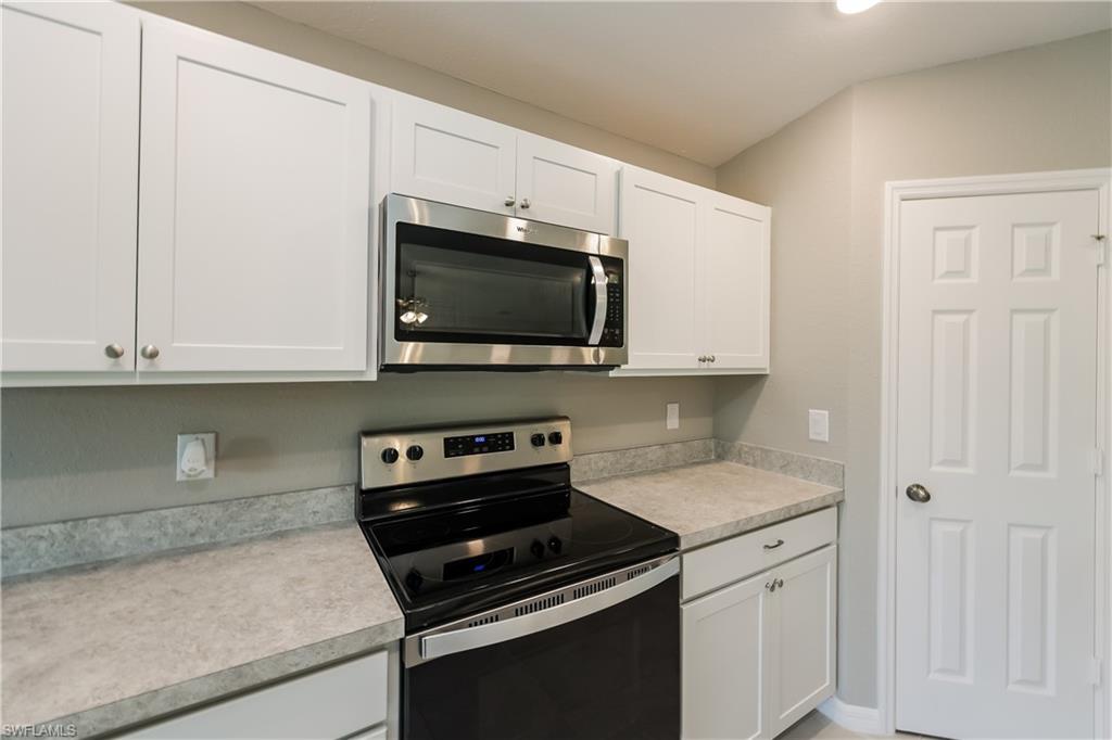 1218 Beaver Street East Lehigh Acres, FL 33974 - Photo 6 of 15 a kitchen with a sink and a stove top oven