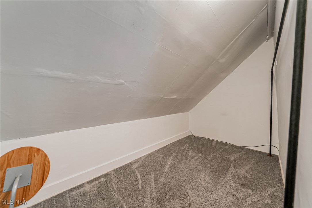 13614 Granger Road Cleveland, OH 44125 - Photo 17 of 38 Additional living space featuring carpet flooring and vaulted ceiling