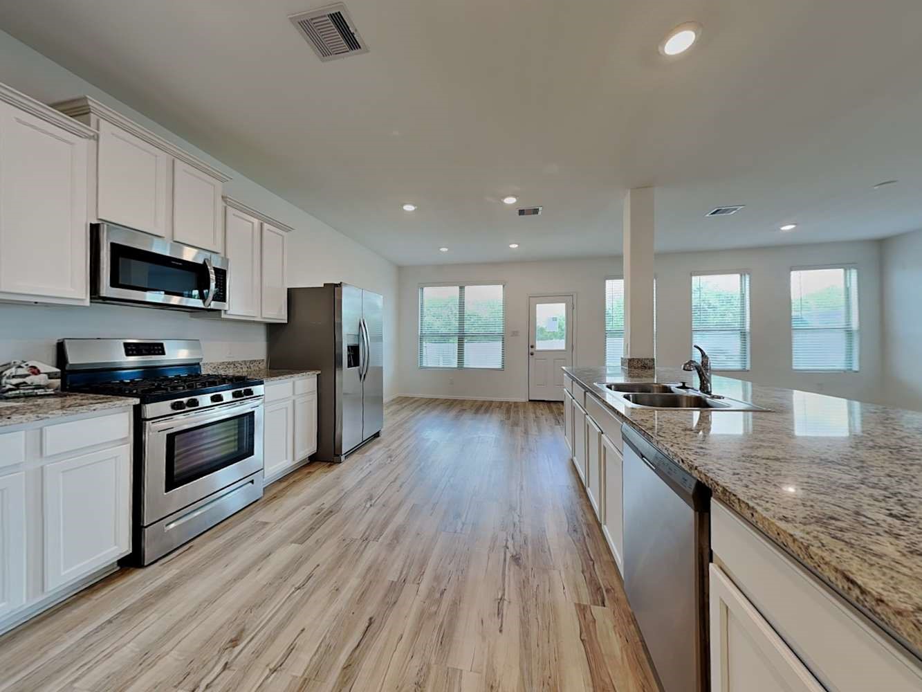 18743 Jasper Rdg Drive Hockley, TX 77447 - Photo 8 of 15 a large kitchen with stainless steel appliances granite countertop a lot of counter space a stove and a wooden floors