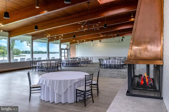 a dining room with furniture and a floor to ceiling window