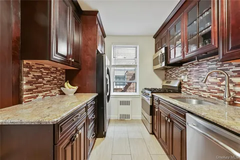 a kitchen with stainless steel appliances granite countertop a stove and a sink