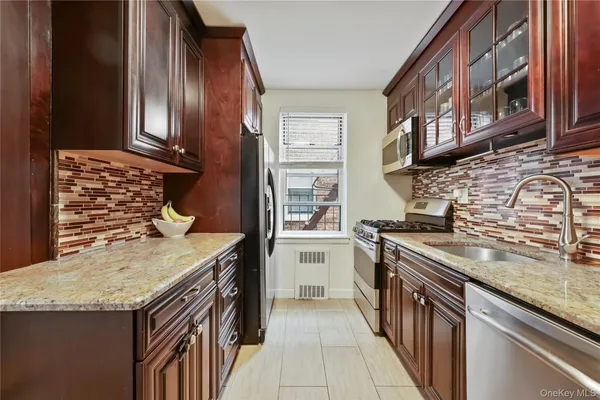 a kitchen with stainless steel appliances granite countertop a stove and a sink
