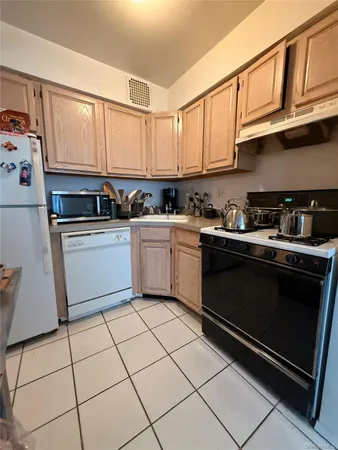 a kitchen with stainless steel appliances granite countertop a sink stove top oven and cabinets
