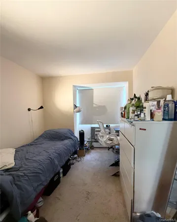 a bedroom with bed and window