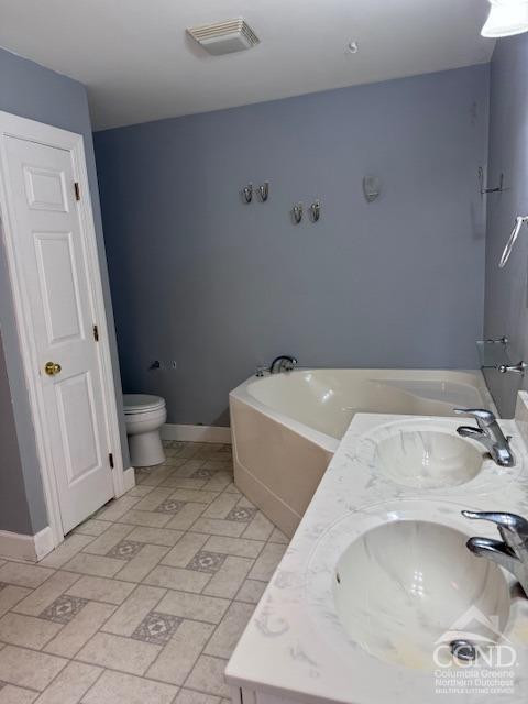 114 La Corte Road Catskill, NY 12414 - Photo 19 of 29 a bathroom with a granite countertop sink and toilet