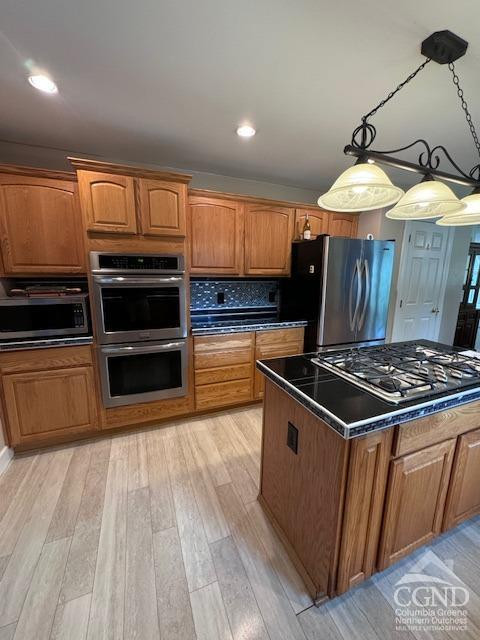 114 La Corte Road Catskill, NY 12414 - Photo 9 of 29 a kitchen with wooden floors and a stove top oven