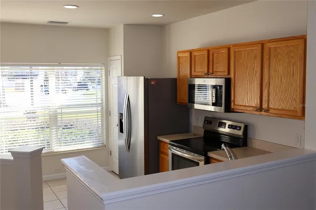 a kitchen with a refrigerator and a stove