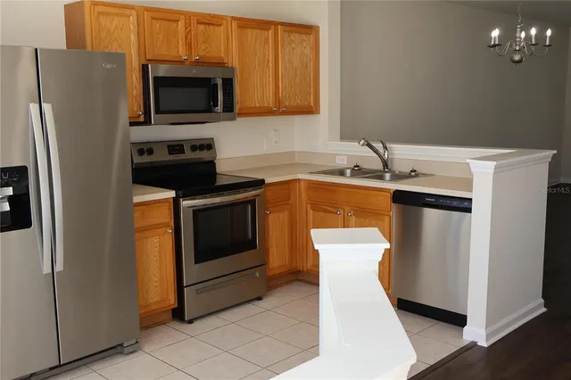 a kitchen with a sink and steel appliances