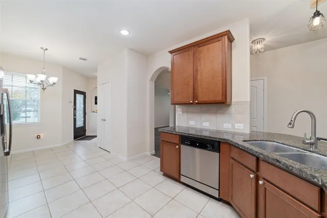 a kitchen with stainless steel appliances granite countertop a sink and a stove