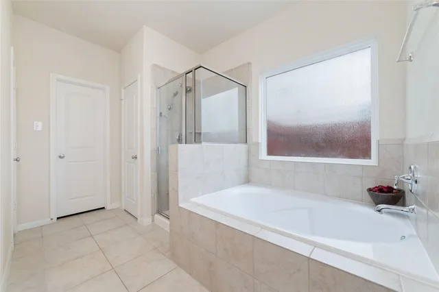 a bathroom with a bathtub and a shower