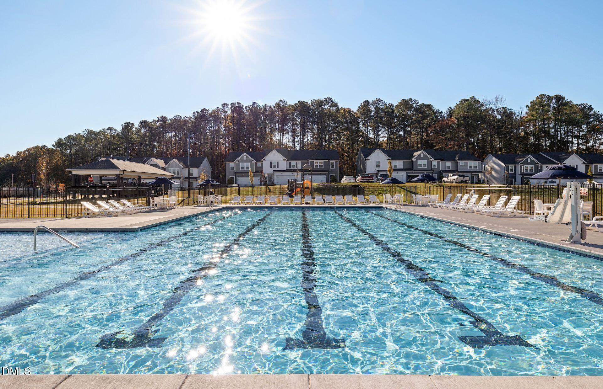 5003 Reader Way Durham, NC 27703 - Photo 26 of 30 a view of a swimming pool with an outdoor seating and a garden