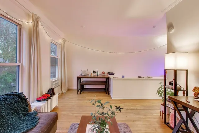 a bedroom with furniture and a wooden floor