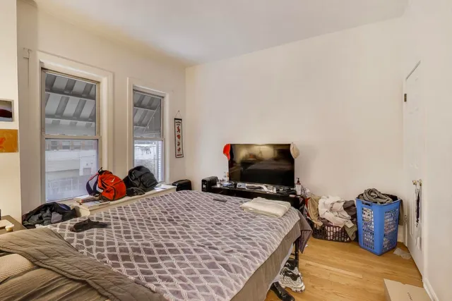 a bedroom with a bed and flat screen tv