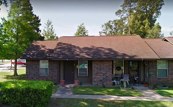 a front view of a house with a garden and porch