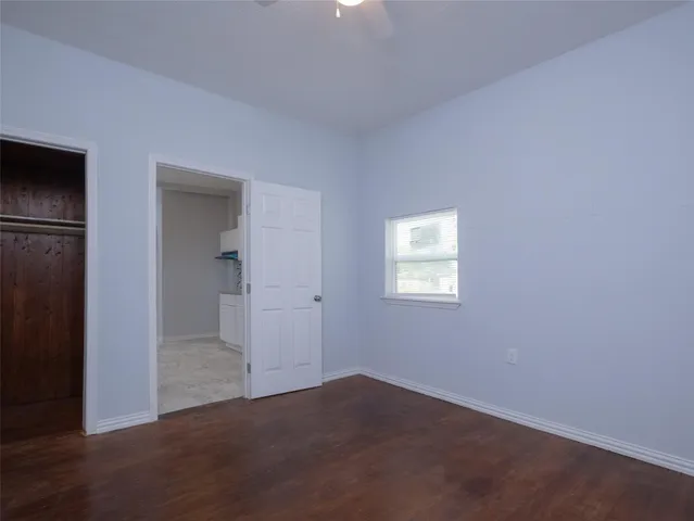 a view of an empty room and closet area