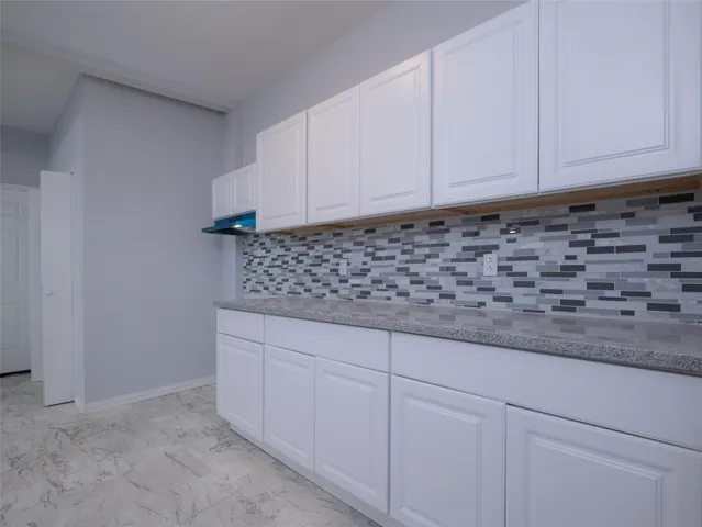 a view of white cabinets and sink
