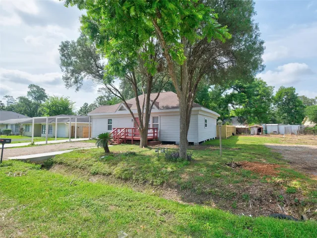 a backyard of a house with table and chairs