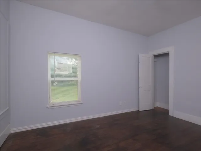 a view of a yard in front of a house with large trees