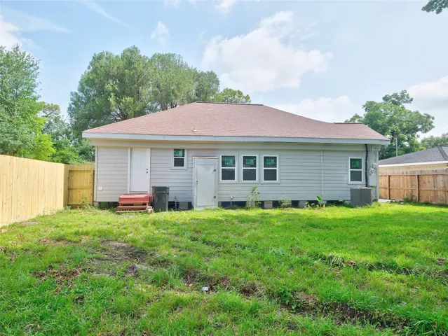 a view of a backyard with large trees