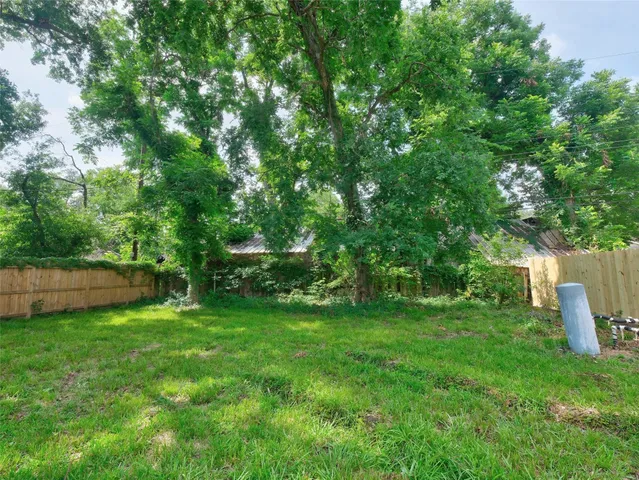 a view of a house with a backyard and a garden