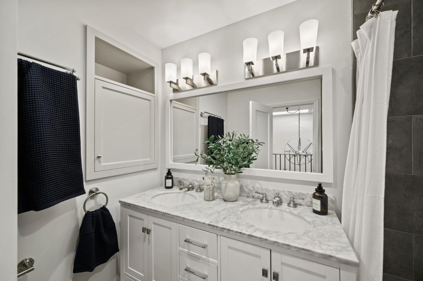 670 Edgewood Road San Mateo, CA 94402 - Photo 24 of 59 a bathroom with a granite countertop sink and a mirror