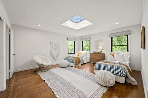 a bedroom with a large bed and a window