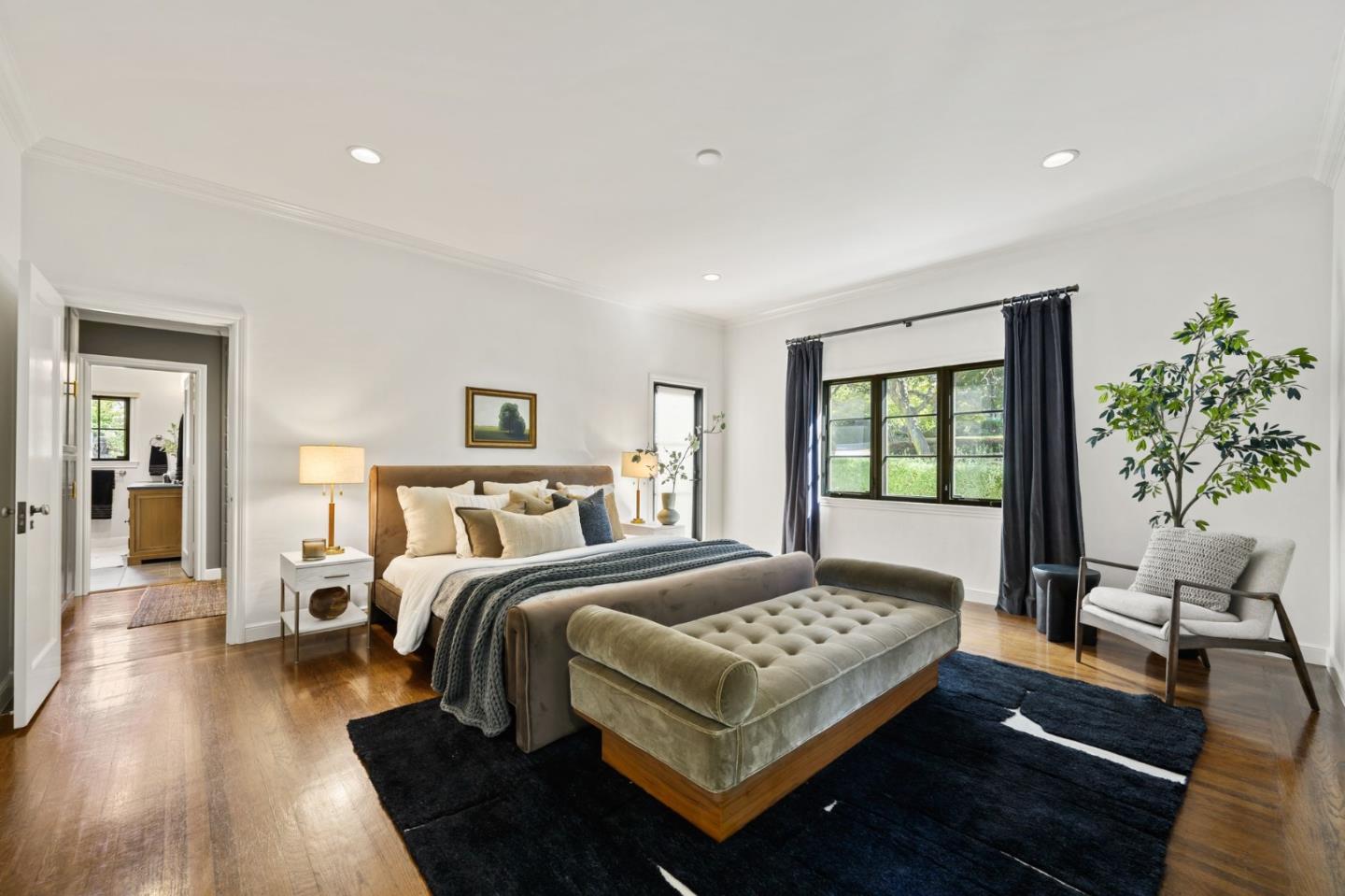 670 Edgewood Road San Mateo, CA 94402 - Photo 28 of 59 a bedroom with a large bed and a potted plant