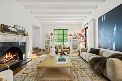 a living room with furniture and a floor to ceiling window