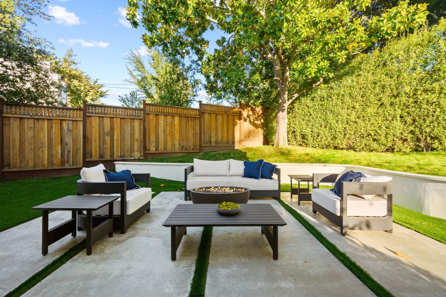 670 Edgewood Road San Mateo, CA 94402 - Photo 43 of 59 a view of a chairs and table in the back yard of the house