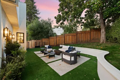 an aerial view of a house with a yard and parking