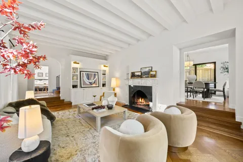 a kitchen with stainless steel appliances granite countertop a sink a stove a refrigerator cabinets and living room view